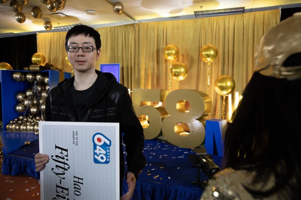 Hao Ping Chung, who lives with his parents, said he plans to buy his own home with some of the $58 million that he won. He picked up the cheque in Vancouver on Friday. (Nav Rahi/CBC - image credit)