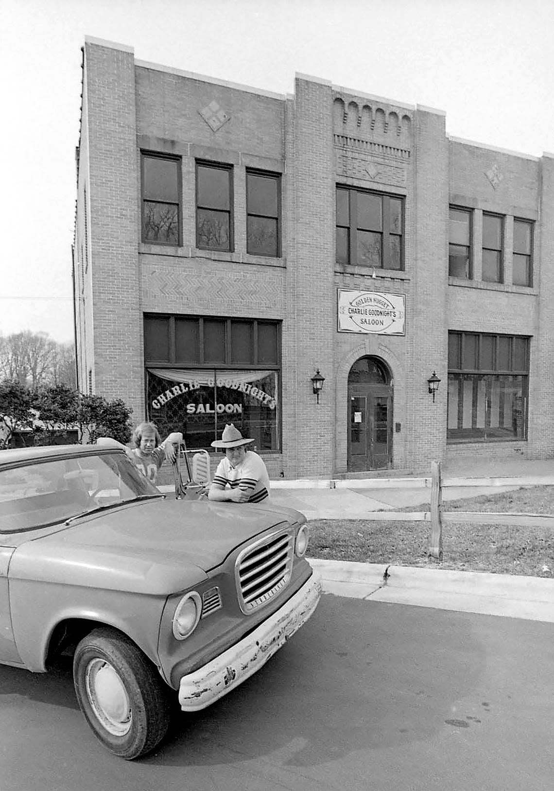 Owners, Chip Lovell (left) and Garry Hoover are seen in front of Charlie Goodnight’s Saloon, February 11, 1975.
Lovell and Hoover purchased the vacant White’s Dairy Building in  1974 for $75,000 and renovated the interior, eventually opening Charlie Goodnight’s Saloon in 1974. 