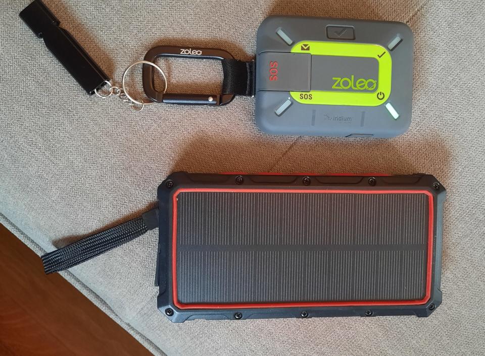 Dane Cramer's Zoleo satellite communicator is pictured beside a solar panel battery pack that is used to recharged his cellphone in the wilderness. The two devices can keep him connected to the world while on remote camping adventures.