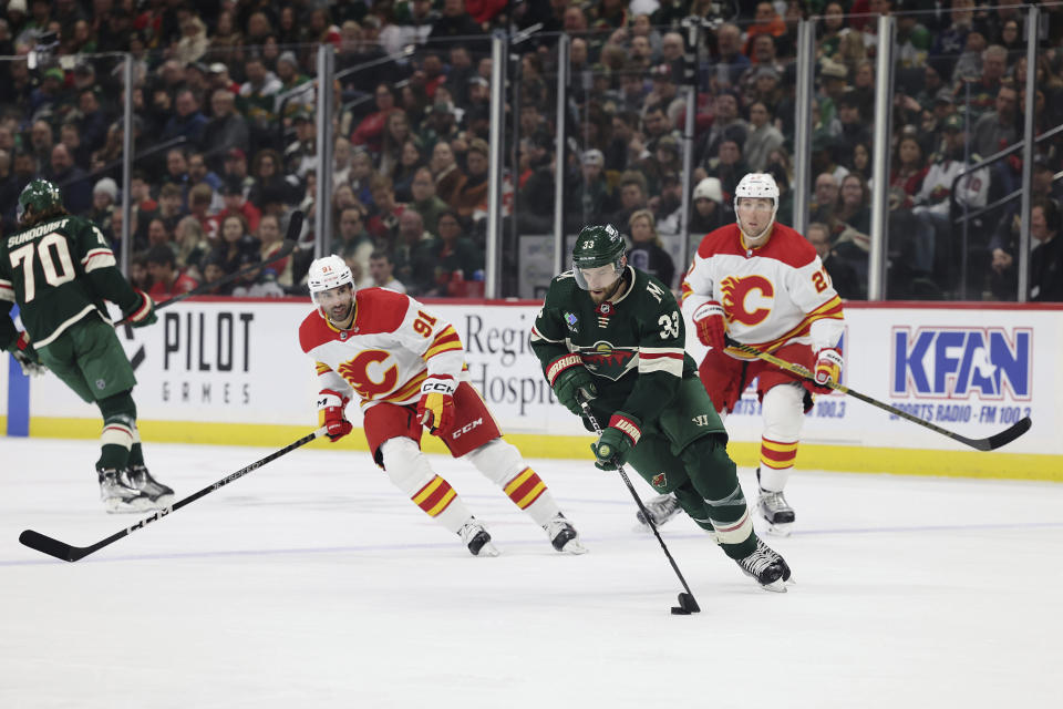 Minnesota Wild defenseman Alex Goligoski (33) works with the puck during the second period of the team's NHL hockey game against the Calgary Flames on Tuesday, March 7, 2023, in St. Paul, Minn. (AP Photo/Stacy Bengs)