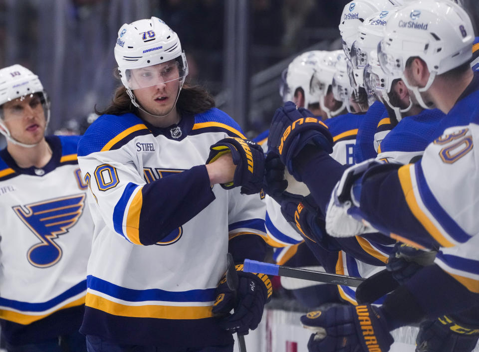 St. Louis Blues center Oskar Sundqvist (70) is congratulated for a goal against the Seattle Kraken during the first period of an NHL hockey game Friday, Jan. 26, 2024, in Seattle. (AP Photo/Lindsey Wasson)