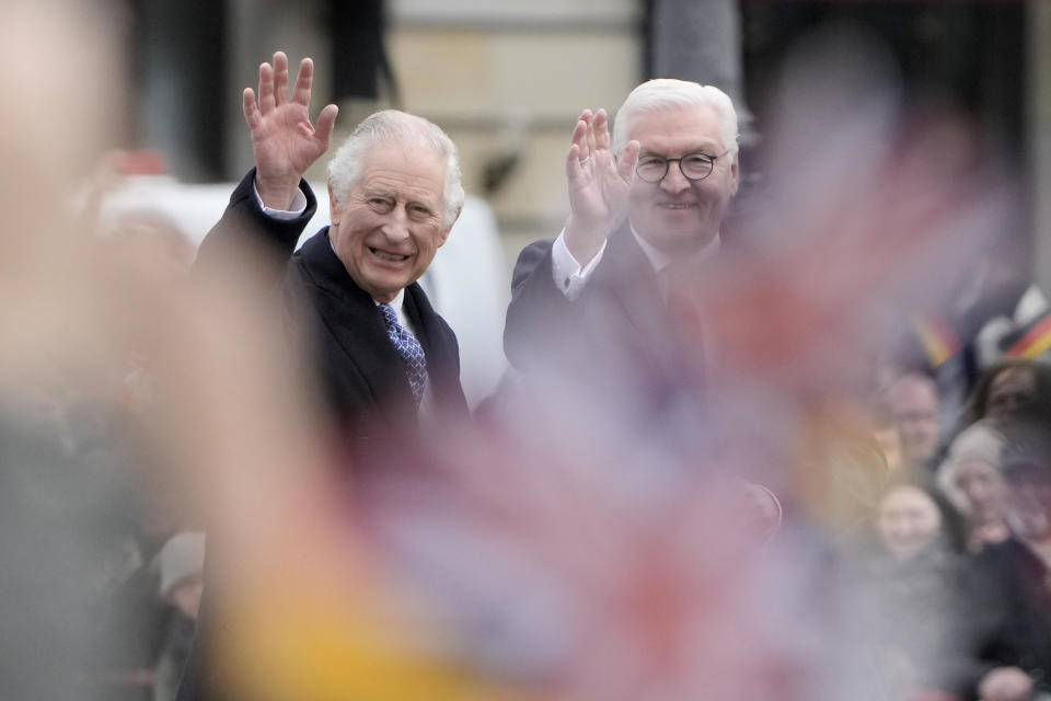 FILE - German President Frank-Walter Steinmeier, right, and Britain's King Charles III wave to well-wishers during a welcome ceremony in front of the Brandenburg Gate in Berlin, Tuesday, March 29, 2022. King Charles III won plenty of hearts during his three-day visit to Germany, his first foreign trip since becoming king following the death of his mother, Elizabeth II, last year. (AP Photo/Markus Schreiber, File)