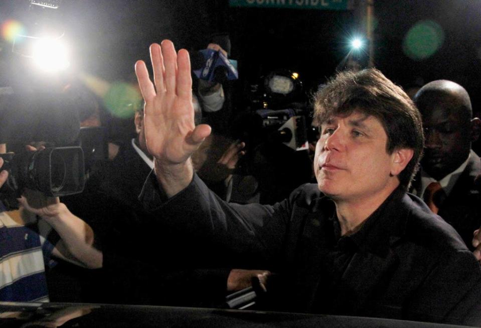 Former Illinois Gov. Rod Blagojevich waves as he departs his Chicago home for Littleton, Colo., in 2012 to begin his 14-year prison sentence on corruption charges.