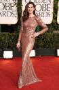 <p>Anne Hathaway went for a strong shoulder and lots of sparkle in her rose gold Armani Privé gown.</p>