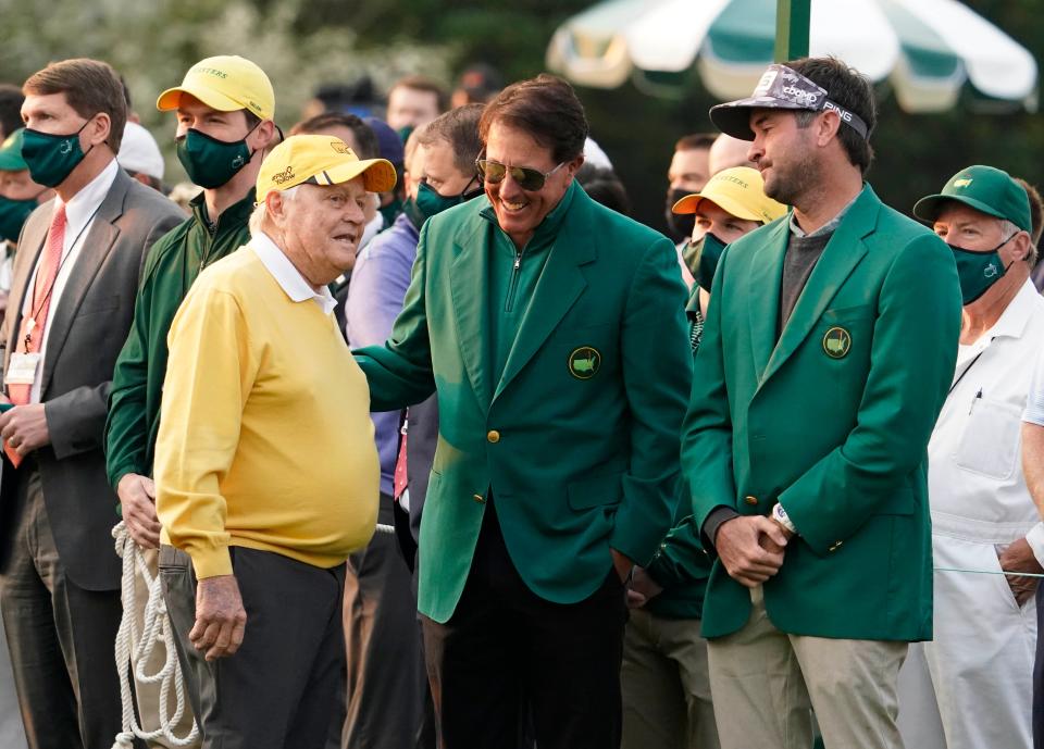 Honorary starter Jack Nicklaus greets Phil Mickelson and Bubba Watson during the first round of the 2021 Masters in Augusta, Georgia.