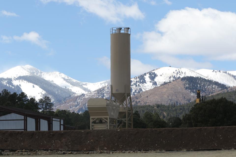 A silo at Roper Construction's concrete batch plant blocks a mountainous view from the property of Pete Blanchard, March 27, 2024 in Alto.