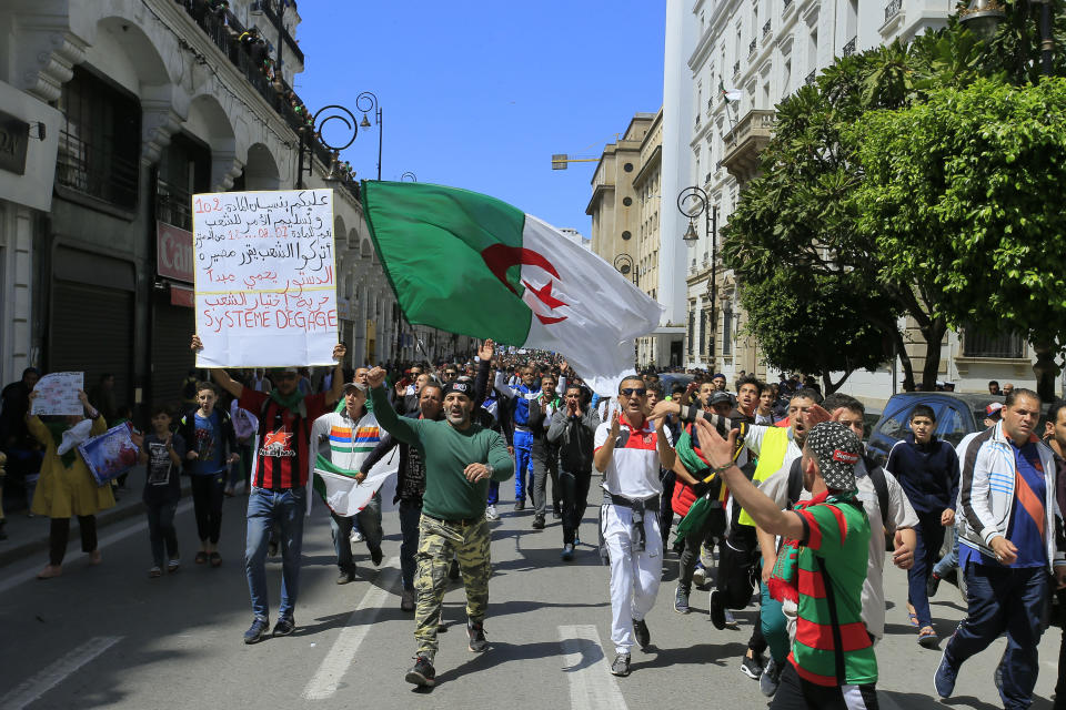 Demonstrators chant slogans during a protest in Algiers, Friday, April 26, 2019. Algerians are massing for a 10th week of protests against their country's ruling class, calling for the ex-president's brother to be put on trial. (AP Photo/Anis Belghoul)