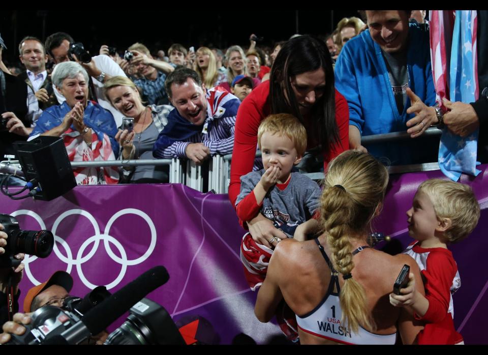 United States' Kerri Walsh Jennings celebrates with her boys Joey and Sundance after winning the women's gold medal beach volleyball match at the 2012 Summer Olympics, Wednesday, Aug. 8, 2012, in London. 