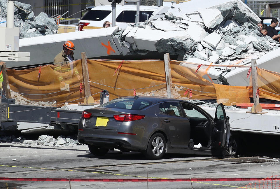 Miami-Dade Fire Rescue personnel and other rescue units work at the scene where a pedestrian bridge collapsed.