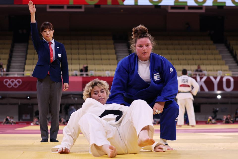 Israel's Raz Hershko (blue) and Saudi Arabia's Tahani Alqahtani compete in the judo women's +78kg elimination round bout during the Tokyo 2020 Olympic Games at the Nippon Budokan in Tokyo on July 30, 2021. (Photo by Jack GUEZ / AFP) (Photo by JACK GUEZ/AFP via Getty Images)