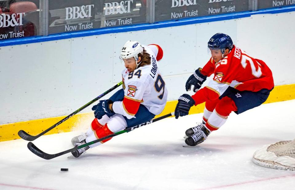 Florida Panthers defenseman Brady Keeper (25) battle for the puck against Panthers left wing Ryan Lomberg (94) during the first period of the first training camp scrimmage in preparation for the 2021 NHL season at the BB&T Center on Thursday, January 7, 2021 in Sunrise.