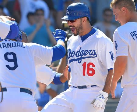 Aug 2, 2015; Los Angeles, CA, USA; Los Angeles Dodgers right fielder Andre Ethier (16) is met at home by catcher Yasmani Grandal (9) and center fielder Joc Pederson (31) after hitting a walk off home run in the tenth inning of the game against the the Los Angeles Angels at Dodger Stadium. Dodgers won 5-3. Jayne Kamin-Oncea-USA TODAY Sports