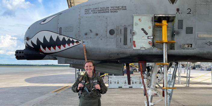 Capt. Taylor &quot;Petrie&quot; Bye standing in front of her A-10 attack aircraft
