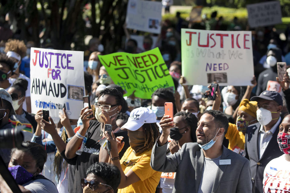 People react during a rally to protest the shooting of Ahmaud Arbery, an unarmed black man Friday, May 8, 2020, in Brunswick Ga. Two men have been charged with murder in the February shooting death of Arbery, whom they had pursued in a truck after spotting him running in their neighborhood. (AP Photo/John Bazemore)