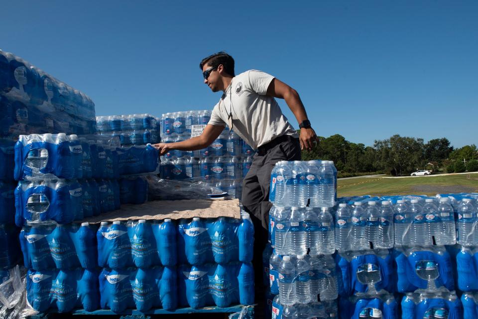 Joey Whibbs with the Florida Department of Environmental Protection prepares water to distribute to Santa Rosa County residents Oct. 22. The water distribution comes after a contractor mistakenly connected a sewer line to the water main supplying water to some 300 residents along Soundside Drive.