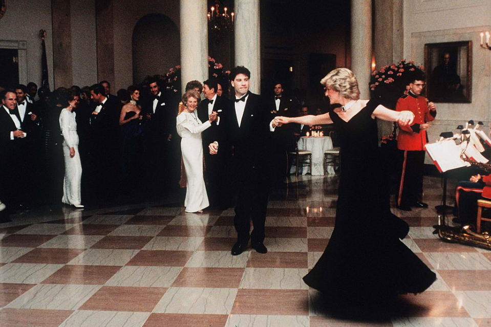 Diana dances With John Travolta in a midnight blue velvet dress by Victor Edelstein. <em>(Photo: Getty)</em>