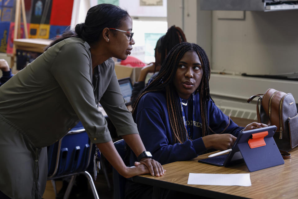 S'Heelia Marks gives instruction to Rachel Morrow to prepare her for the digital SAT, Wednesday, March 6, 2024, at Holy Family Cristo Rey Catholic High School in Birmingham, Ala. (AP Photo/Butch Dill)