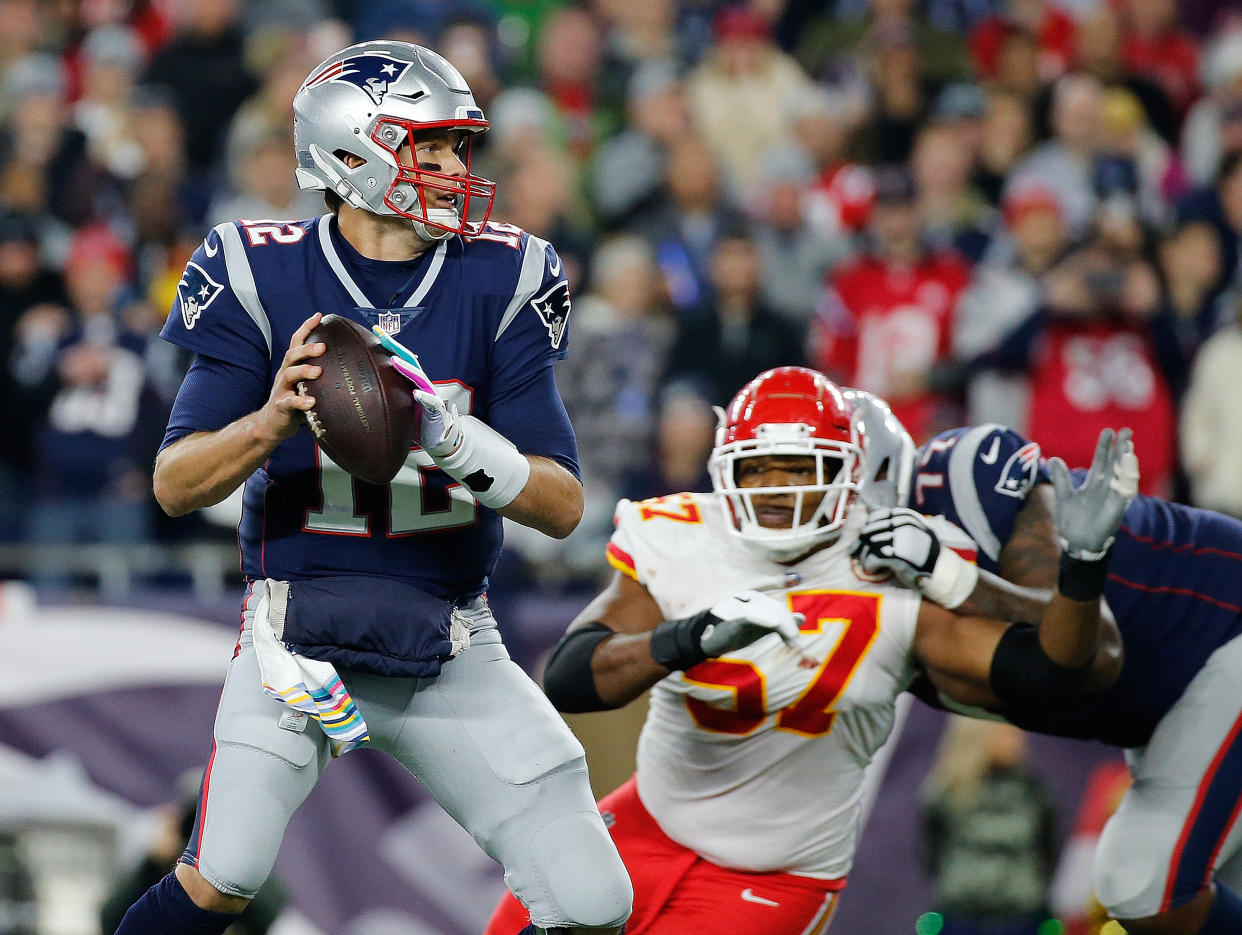 Tom Brady escaped the clutches of the Chiefs’ Breeland Speaks to score a touchdown late on Sunday night. (Getty Images)