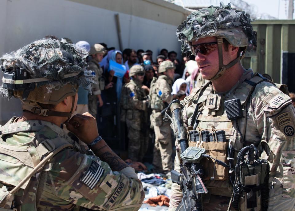 Paratroopers assigned to 1st Brigade Combat Team, 82nd Airborne Division discuss upcoming operations at Hamid Karzai International Airport in Kabul, Afghanistan on Aug. 25, 2021