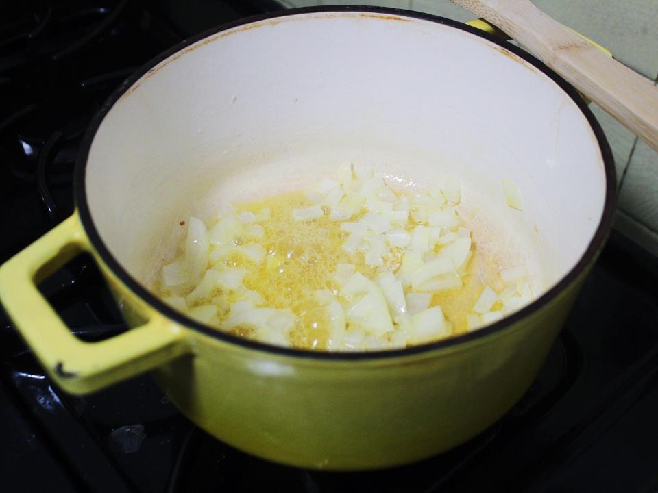 onions and butter in a yellow pot on a stove
