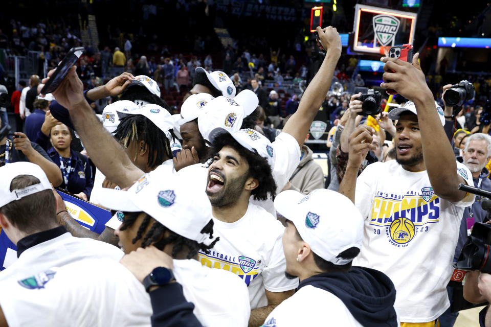Kent State players celebrate after defeating Toledo in an NCAA college basketball game to win the championship of the Mid-American Conference Tournament, Saturday, March 11, 2023, in Cleveland. (AP Photo/Ron Schwane)
