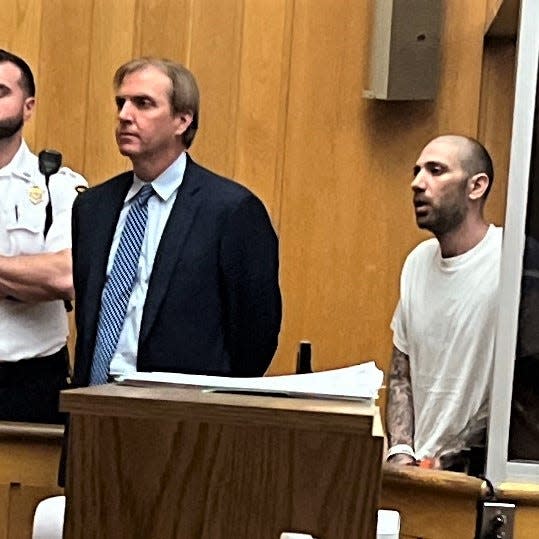 Christopher Smith, right, was arraigned on a murder charge Tuesday, May 7, in New Bedford District Court. At left is his attorney, James Hanley.