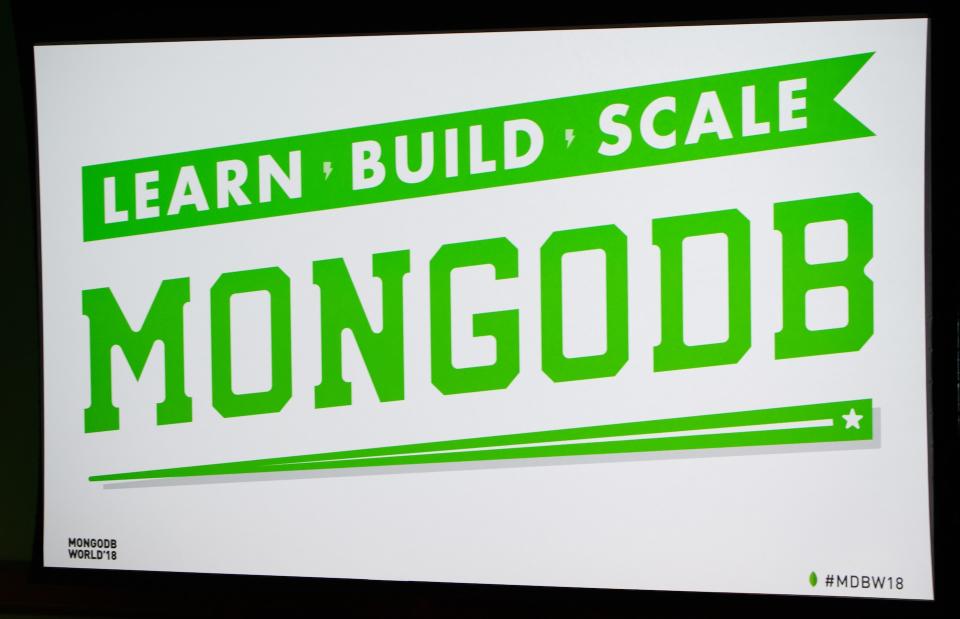 Green and white promo board with MongoDB logo and slogan on it.