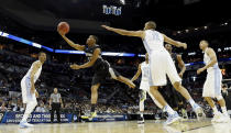 Providence's Bryce Cotton, left, goes up for a shot as North Carolina's Brice Johnson, right, defends during the first half of a second-round game in the NCAA college basketball tournament Friday, March 21, 2014, in San Antonio. (AP Photo/David J. Phillip)