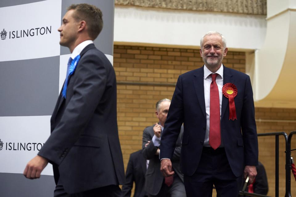 Labour party leader Jeremy Corbyn (R) smiles as he arrives for the results to be declared at the count centre in Islington, London, early in the morning of June 9, 2017, hours after the polls closed in Britain's general election.   The main opposition Labour party, led by leftist Jeremy Corbyn, was on course to increase its number of seats from 229 to 266, according to the joint exit poll by Sky, the BBC and ITV. / AFP PHOTO / NIKLAS HALLE'N        (Photo credit should read NIKLAS HALLE'N/AFP via Getty Images)