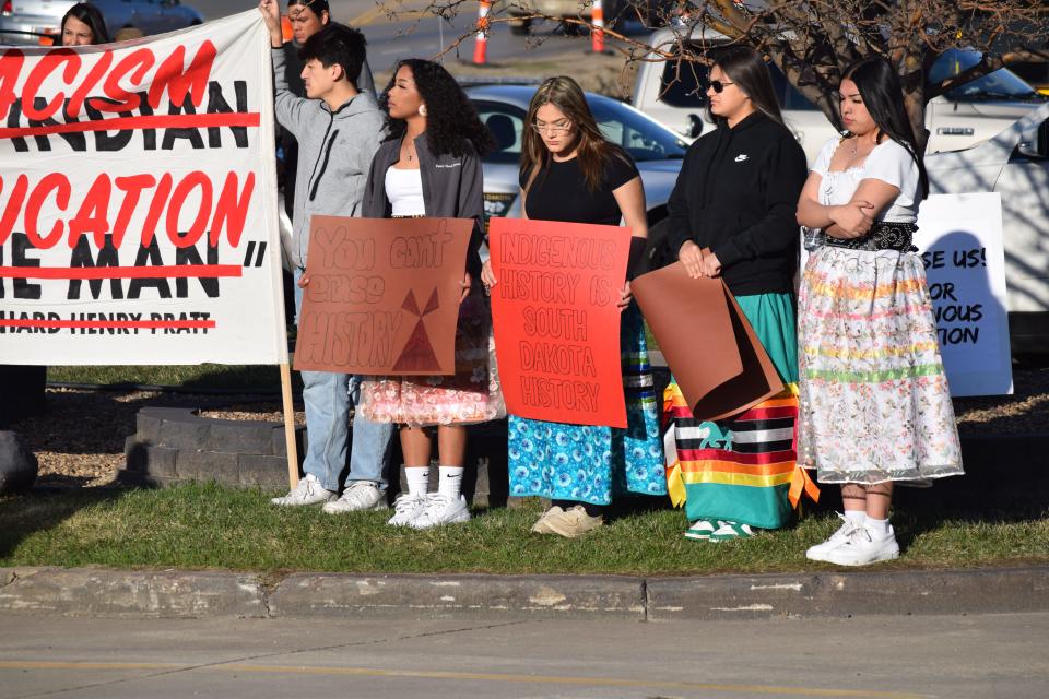 Students stand in opposition to the proposed social studies standards ahead of a Board of Education Standards meeting in Pierre on April 17, 2023. From right to left: Alyssa Plamk, Lizee DuBray, Emilee DuBray, Gabrielle Kenny and Honz Fuller.