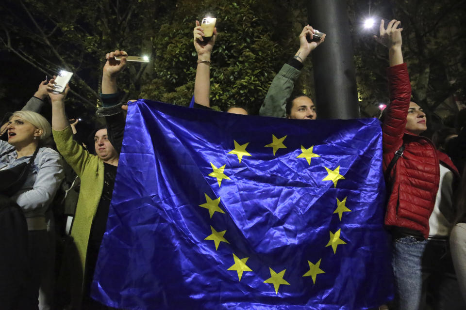 Protestors gather outside the parliament building in Tbilisi, Georgia, on Tuesday, April 16, 2024, to protest against "the Russian law" similar to a law that Russia uses to stigmatize independent news media and organizations seen as being at odds with the Kremlin. (AP Photo/Zurab Tsertsvadze)