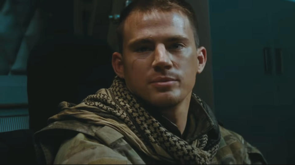 Channing Tatum smiles slightly dressed in tactical desert gear in G.I. Joe: The Rise of Cobra.