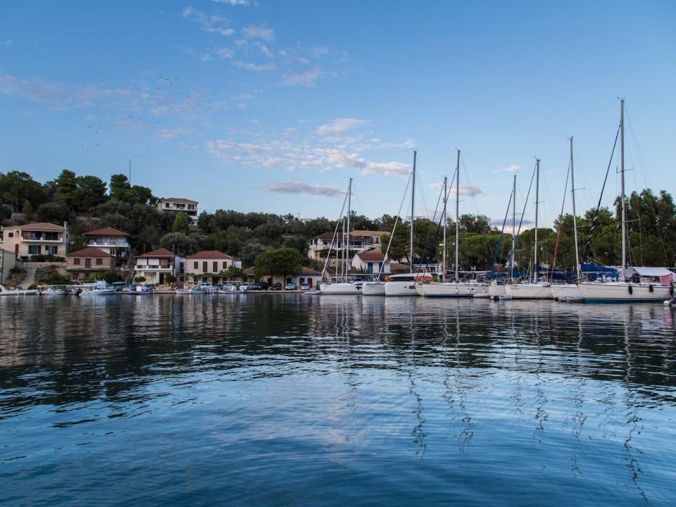 boats docked in bathi marina in greece on a clear day