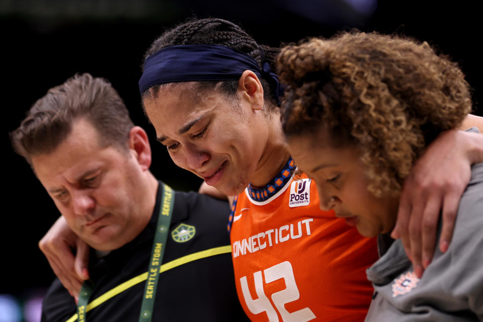 Connecticut Sun forward Brionna Jones is helped off the court with an injury during the fourth quarter against the Seattle Storm at Climate Pledge Arena in Seattle on June 20, 2023. (Steph Chambers/Getty Images)