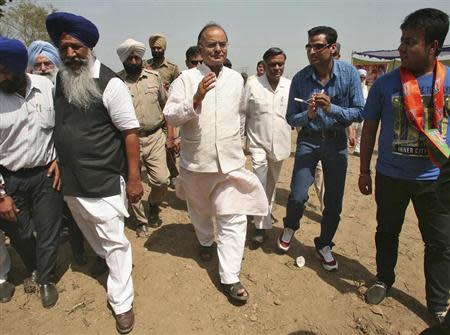 Arun Jaitley, a senior leader of India's main opposition Bharatiya Janata Party (BJP), greets his party's supporters as he arrives to attend an election campaign rally in his constituency in the northern Indian city of Amritsar April 11, 2014. REUTERS/Munish Sharma