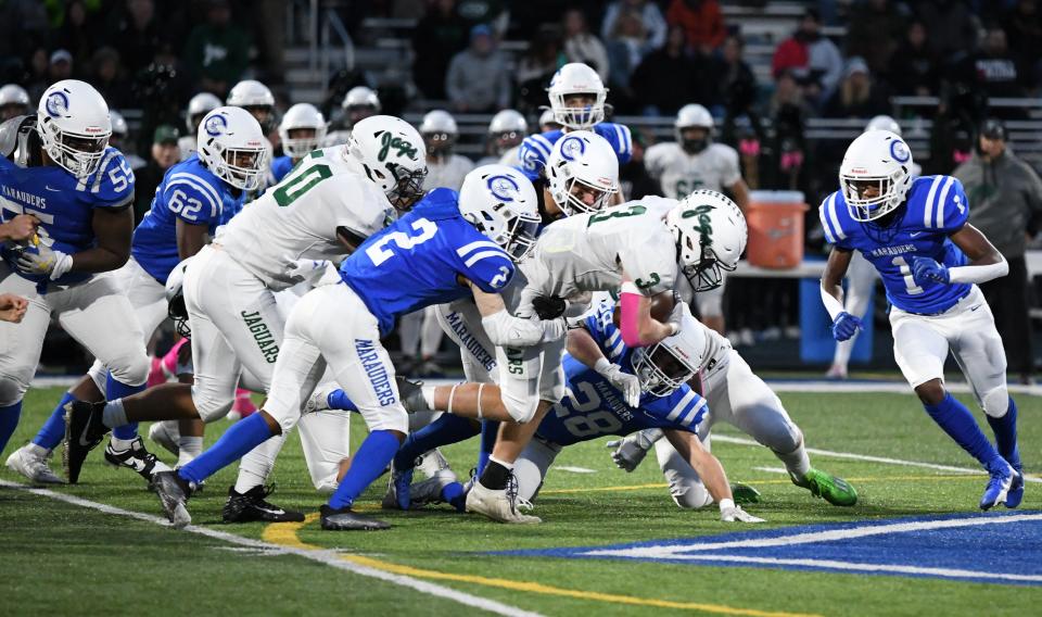 The Gibraltar Carlson defense swarms around an Allen Park ballcarrier during a 20-18 Marauder victory Friday night.