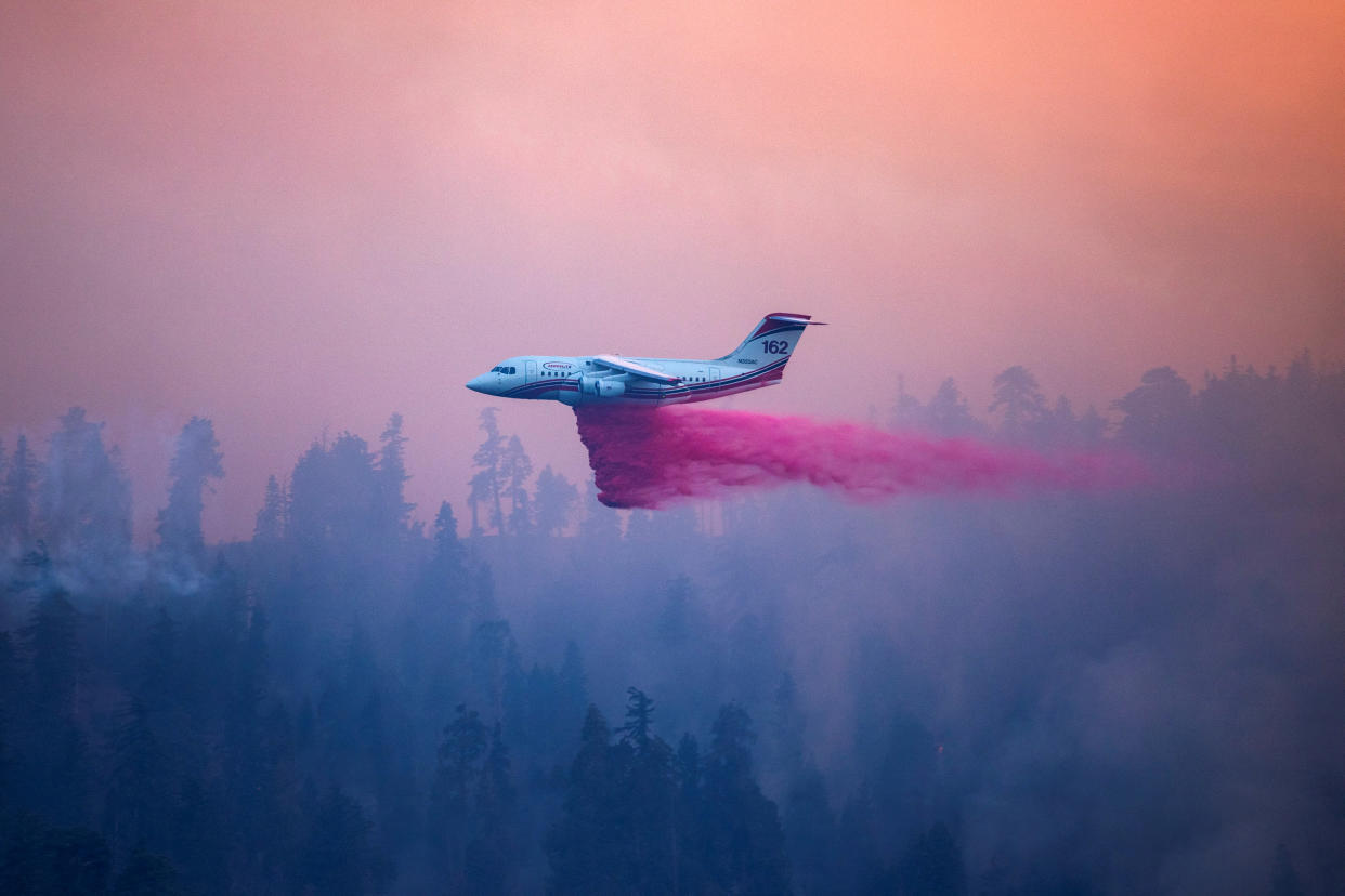 A plane drops retardant on the Bridge Fire in Wrightwood, Calif., on Wednesday.