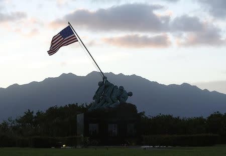 A smaller version of the United States Marine Corps Iwo Jima Memorial in Arlington, Virginia is seen at sunset at Marine Corps Base Hawaii December 31, 2014. REUTERS/Gary Cameron/Files
