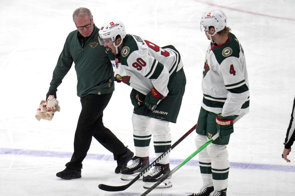 Minnesota Wild's Marcus Johansson (90) is helped off the ice after being injured during the first period of an NHL hockey game against the Pittsburgh Penguins in Pittsburgh, Monday, Dec. 18, 2023. (AP Photo/Gene J. Puskar)