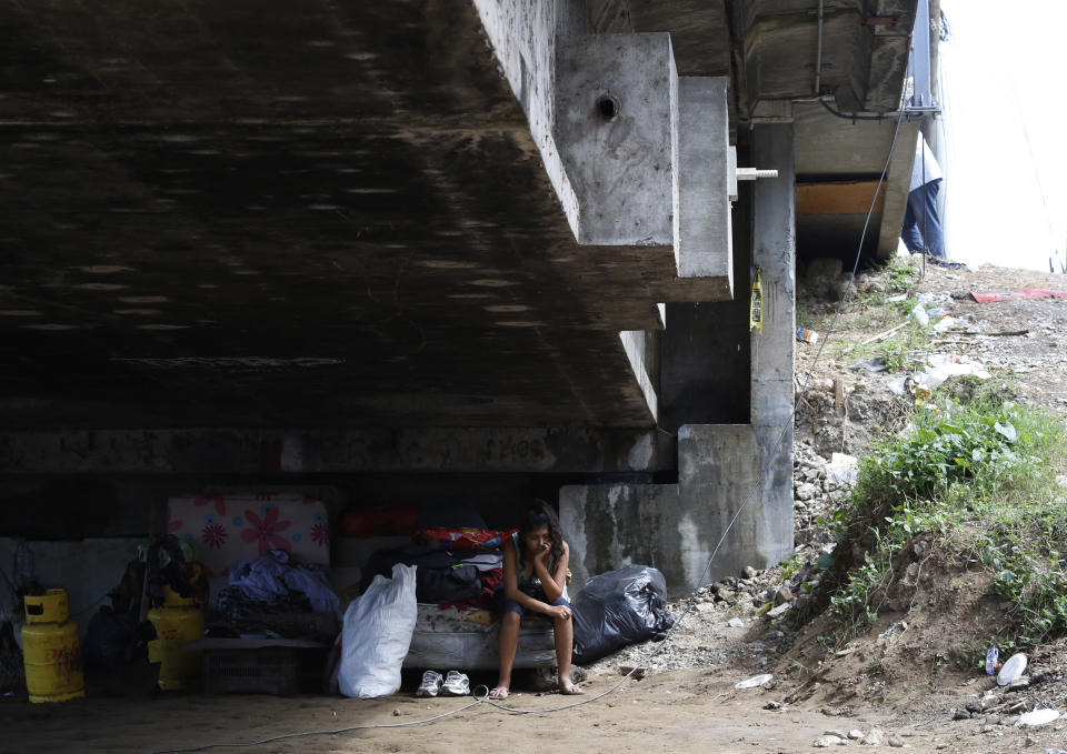 Mileydi Duarte, who was evacuated today by her family, rests under a highway bridge as she waits for space at a shelter before Hurricane Iota makes landfall in El Progreso Yoro, Honduras, Monday, November 16, 2020. Hurricane Iota rapidly strengthened into a Category 5 storm that is likely to bring catastrophic damage to the same part of Central America already battered by a powerful Hurricane Eta less than two weeks ago. (AP Photo/Delmer Martinez)