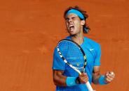 FILE PHOTO: Spain's Rafa Nadal celebrates victory against American John Isner in the French Open first round at Roland Garros in Paris.