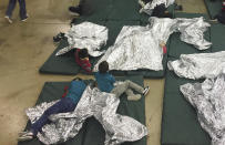 <p>People who’ve been taken into custody related to cases of illegal entry into the United States, rest in one of the cages at a facility in McAllen, Texas, Sunday, June 17, 2018. (Photo: U.S. Customs and Border Protection’s Rio Grande Valley Sector via AP) </p>