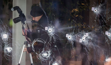 Investigative personnel work at the scene of a cafe shooting in Oesterbro, in Copenhagen, February 15, 2015. REUTERS/Hannibal Hanschke