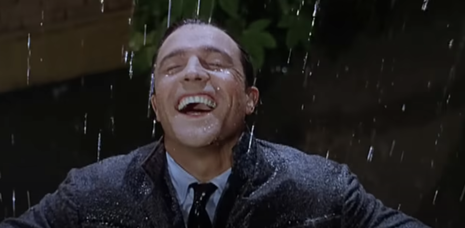 Man smiles in the rain