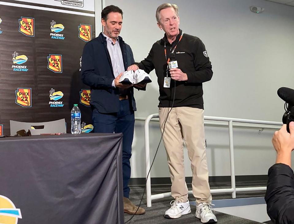 Maury Gallagher, right, presents Jimmie Johnson with â€œofficial team owner shoesâ€ now that Johnson is part-owner of Petty GMS during a press conference at Phoenix Raceway in Avondale, Ariz., Friday, Nov. 4, 2022. Johnson's NASCAR retirement and IndyCar experiment lasted all of two seasons. The seven-time NASCAR champion is returning in 2023 to the series that made him a global motorsports star as the part-owner of Petty GMS. He'll also enter about five Cup races. (AP Photo/Jenna Fryer)