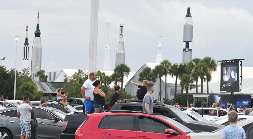 Spectators get in place to watch a  SpaceX Falcon 9 rocket launch near the rocket garden area of the Kennedy Space Center Visitor Complex, which is Brevard County's most popular paid tourist attraction.