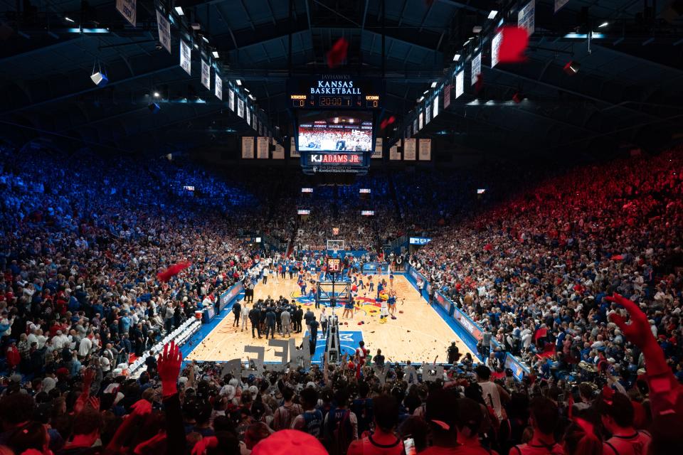 Kansas basketball fans scream and cheer before the start of a game against the UConn Huskies inside Allen Fieldhouse during the 2023-24 season.