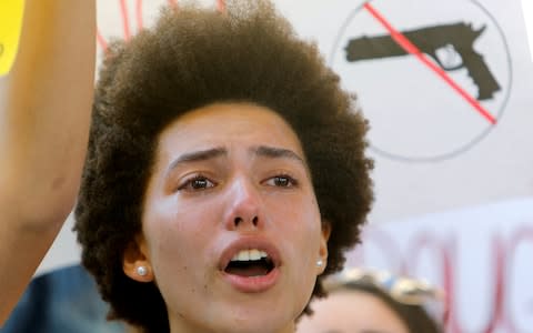 A protester weeps while chanting at a rally calling for more gun control three days after the shooting at Marjory Stoneman Douglas High School, in Fort Lauderdale - Credit: Reuters