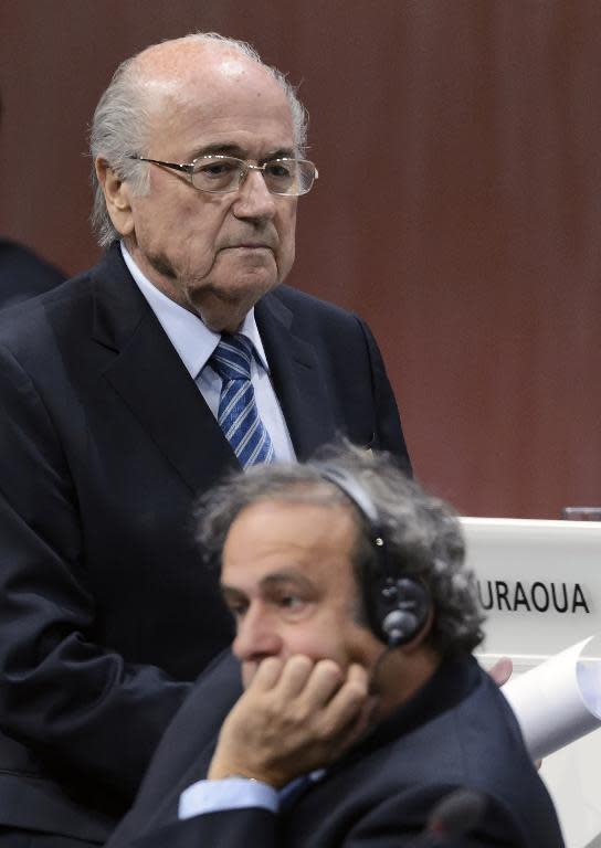 FIFA president Sepp Blatter walks behind UEFA president Michel Platini at the congress in Zurich