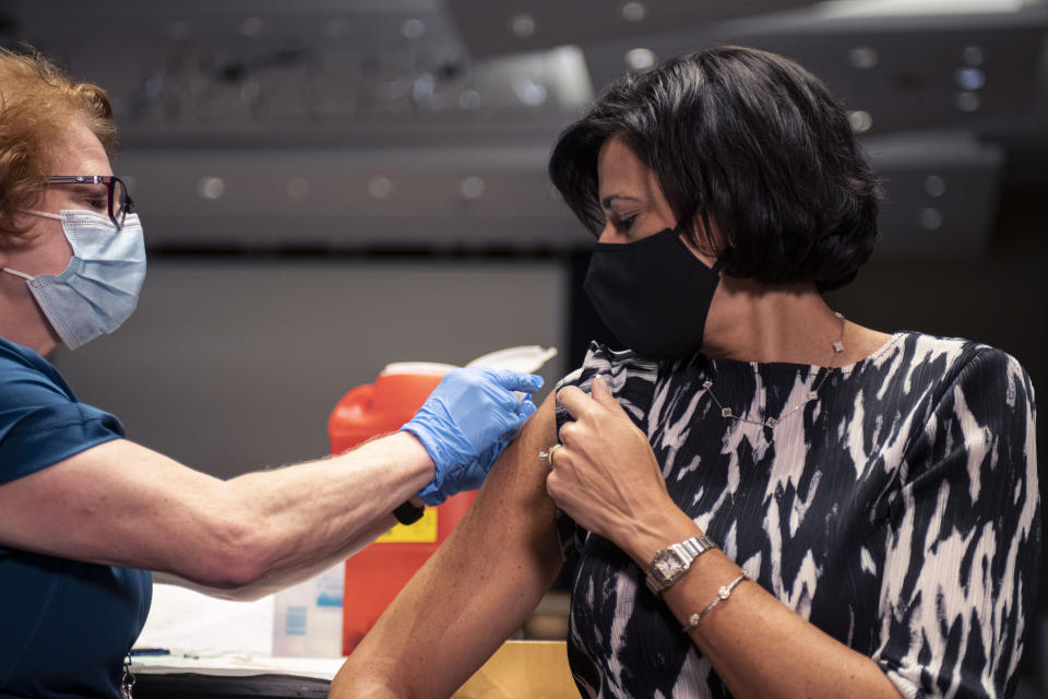 In this photo provided by the National Foundation for Infectious Diseases, CDC Director Rochelle Walensky receives her flu shot on Tuesday, Oct. 5, 2021 in Atlanta. The U.S. is gearing up in case of a bad flu season on top of the continuing COVID-19 crisis, with a plea Thursday for Americans to get vaccinated against both. (National Foundation for Infectious Diseases via AP)